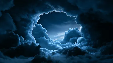 Dark storm clouds part to open a window of pale blue sky in the middle of the frame.