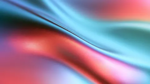 Desktop wallpaper of soft red and teal silk waves blending together.
