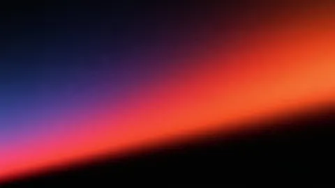 Desktop wallpaper of a soft orange light sweep fading into deep blue.