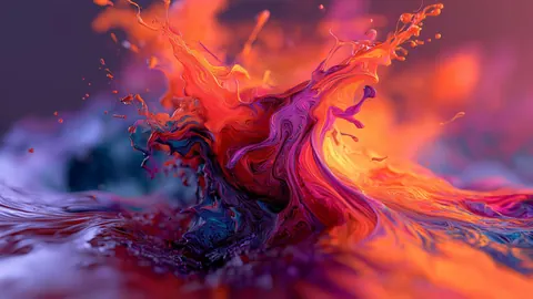 A splash of magenta, orange and violet liquid bursts upward in a swirl of color.