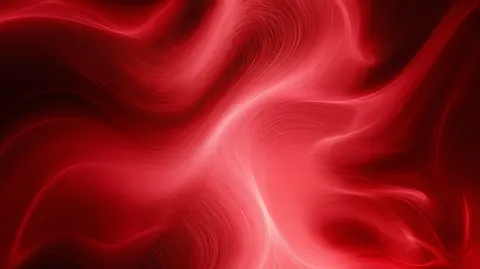 Fine scarlet fibers swirl and knot together like smoke caught in red light.